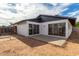 View of home's backyard with patio and sliders at 1228 E Fremont Dr, Tempe, AZ 85282