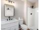 Bright bathroom features a vanity with a marble countertop, a mirror, and a shower at 1228 E Fremont Dr, Tempe, AZ 85282