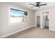 A carpeted bedroom features a window, closet, and an attached bathroom for convenience at 1228 E Fremont Dr, Tempe, AZ 85282