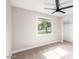 This bedroom offers a ceiling fan, closet, and a window with a view of the outdoors at 1228 E Fremont Dr, Tempe, AZ 85282