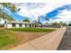 Lovely single story home featuring a carport and a vibrant green front lawn at 1228 E Fremont Dr, Tempe, AZ 85282