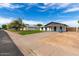 Street view of a single story home with a spacious carport and tidy lawn at 1228 E Fremont Dr, Tempe, AZ 85282