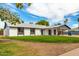 Inviting single story home with a carport, tidy front yard and blue entry door at 1228 E Fremont Dr, Tempe, AZ 85282