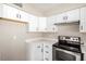 A well-lit kitchen showcases stainless steel appliances, ample white cabinetry, and light countertops at 1228 E Fremont Dr, Tempe, AZ 85282