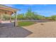 Outdoor space features a covered patio, desert landscaping, gravel, and a lush green lawn at 1336 E Belmont Ave, Phoenix, AZ 85020
