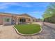 Lush backyard featuring a covered patio, desert landscaping, and a defined green lawn area at 1336 E Belmont Ave, Phoenix, AZ 85020