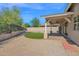 Charming backyard featuring a covered patio, artificial turf, and privacy fence at 1336 E Belmont Ave, Phoenix, AZ 85020