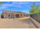 Spacious backyard with desert landscaping, a covered patio, and a gravel area. A small lawn is a central feature at 1336 E Belmont Ave, Phoenix, AZ 85020