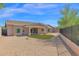 Spacious backyard with desert landscaping, a covered patio, and a gravel area. A lush lawn is a central feature at 1336 E Belmont Ave, Phoenix, AZ 85020