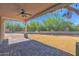 Covered patio and grassy backyard with a block wall fence and desert landscaping at 1336 E Belmont Ave, Phoenix, AZ 85020