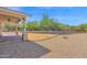 An outdoor living space boasts a covered patio, desert landscaping, and a gravel ground covering at 1336 E Belmont Ave, Phoenix, AZ 85020
