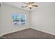 Bright, neutrally decorated bedroom featuring a ceiling fan and carpeted floors at 1336 E Belmont Ave, Phoenix, AZ 85020