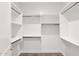Walk-in closet with carpeted floor and multiple levels of shelving and chrome hanging rods on all sides at 1336 E Belmont Ave, Phoenix, AZ 85020