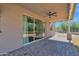Covered patio features a ceiling fan, lighting, and access to the backyard through sliding glass doors at 1336 E Belmont Ave, Phoenix, AZ 85020