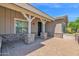 View of the home's covered front porch with brick columns and brick-paved patio at 1336 E Belmont Ave, Phoenix, AZ 85020