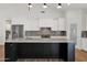 Bright kitchen featuring a large island with dark cabinets and stainless steel appliances at 1336 E Belmont Ave, Phoenix, AZ 85020