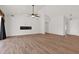 Expansive living room with wood-look tile flooring and a cozy modern fireplace feature at 1336 E Belmont Ave, Phoenix, AZ 85020