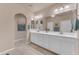 Well-lit bathroom with double sinks, a large mirror, and plenty of counter space at 14200 W Village Pkwy # 2128, Litchfield Park, AZ 85340