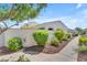 Well-maintained home exterior with lush landscaping, providing a private and serene environment at 14200 W Village Pkwy # 2128, Litchfield Park, AZ 85340