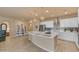 Bright kitchen with a large island, white cabinetry, stainless steel appliances, and modern pendant lighting at 14200 W Village Pkwy # 2128, Litchfield Park, AZ 85340