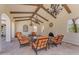 Inviting outdoor lounge with comfortable seating, elegant chandeliers, and a cozy fireplace at 14200 W Village Pkwy # 2128, Litchfield Park, AZ 85340