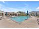 Inviting community pool with plenty of seating, umbrellas, and clear blue water for relaxation at 14200 W Village Pkwy # 2128, Litchfield Park, AZ 85340