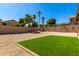 Landscaped backyard with artificial turf, gravel, and a block wall at 15226 S 14Th Dr, Phoenix, AZ 85045