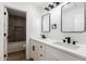 Bathroom featuring double sinks with black hardware, quartz counters, and a shower/tub combo at 15226 S 14Th Dr, Phoenix, AZ 85045