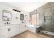 Modern bathroom featuring double sinks, quartz countertop, and glass-enclosed shower with tub at 15226 S 14Th Dr, Phoenix, AZ 85045