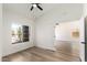 Light and airy bedroom with wood floors, a ceiling fan, and a large window at 15226 S 14Th Dr, Phoenix, AZ 85045