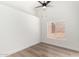 Bright bedroom with a modern ceiling fan, natural light, and wood-look flooring at 15226 S 14Th Dr, Phoenix, AZ 85045
