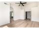 Spacious bedroom with modern ceiling fan, arched doorway, and wood-look flooring at 15226 S 14Th Dr, Phoenix, AZ 85045