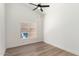 Well-lit bedroom with wood-look flooring, ceiling fan, and natural light from window at 15226 S 14Th Dr, Phoenix, AZ 85045