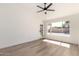 Bright bedroom boasts a modern ceiling fan, wood-look floors, and a window offering natural light at 15226 S 14Th Dr, Phoenix, AZ 85045