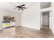 Neutral bedroom featuring wood-look flooring, a ceiling fan, and a sliding glass door at 15226 S 14Th Dr, Phoenix, AZ 85045