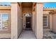 Welcoming entryway with decorative pillars and a security screen door and desert landscape at 15226 S 14Th Dr, Phoenix, AZ 85045