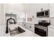Close up of a modern kitchen with stainless appliances and island with sink at 15226 S 14Th Dr, Phoenix, AZ 85045