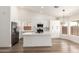 Bright, open kitchen with white cabinetry, stainless appliances, and a kitchen island at 15226 S 14Th Dr, Phoenix, AZ 85045