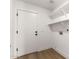 Clean laundry room with shelving and white door at 15226 S 14Th Dr, Phoenix, AZ 85045