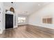 Bright living room with new laminate floors, modern light fixture, and plenty of natural light at 15226 S 14Th Dr, Phoenix, AZ 85045