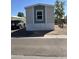 Inviting mobile home featuring neutral siding and a pop of color with an accent wall at 1550 W Southern Ave # 20, Phoenix, AZ 85041