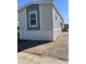 Well-maintained mobile home featuring neutral siding, contrasting accent colors, and updated skirting at 1550 W Southern Ave # 20, Phoenix, AZ 85041