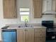 Modern kitchen featuring stainless steel appliances, neutral countertops and light wood cabinets at 1550 W Southern Ave # 20, Phoenix, AZ 85041