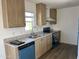 Modern kitchen with light wood cabinets, stainless steel appliances, and laminate countertops at 1550 W Southern Ave # 20, Phoenix, AZ 85041