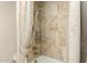 Bathroom shower with decorative tile and brushed gold shower head and fixtures at 15602 N 19Th St, Phoenix, AZ 85022