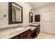 Bathroom with granite counters, undermount sink, warm lighting, and dark wood cabinetry at 15602 N 19Th St, Phoenix, AZ 85022