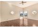 Sunlit bedroom featuring hardwood floors, a ceiling fan, and unique decorative wall cut-outs at 15602 N 19Th St, Phoenix, AZ 85022