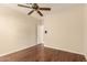 Bedroom features hardwood floors and a ceiling fan with a closet and white trim at 15602 N 19Th St, Phoenix, AZ 85022
