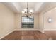 Formal dining room with hardwood floors, elegant chandelier, and a large window at 15602 N 19Th St, Phoenix, AZ 85022