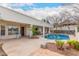 Backyard pool features mature plants, covered patio, and lighting at 15602 N 19Th St, Phoenix, AZ 85022